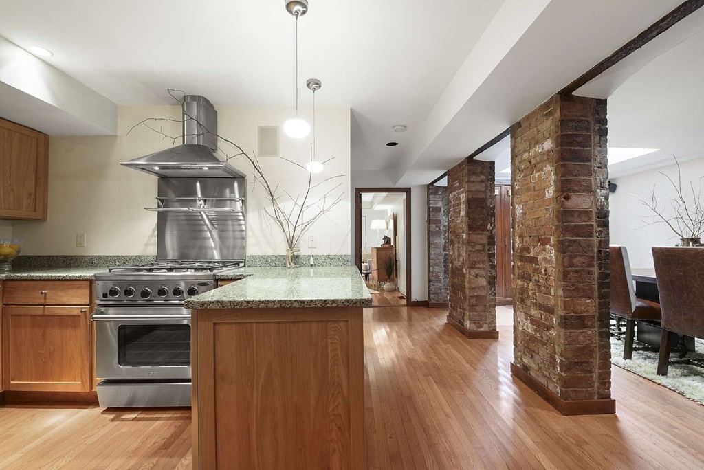 5 Durham Street, Unit 2 Boston, MA 02115 - Photo 13 of 22 a kitchen with stainless steel appliances granite countertop a stove and a wooden floors