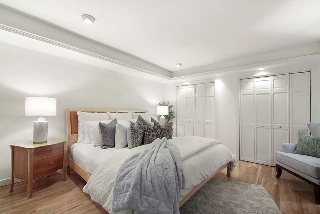 a bedroom with a bed and lamp