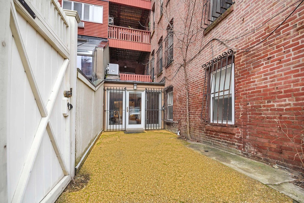 5 Durham Street, Unit 2 Boston, MA 02115 - Photo 20 of 22 a view of a building with many windows