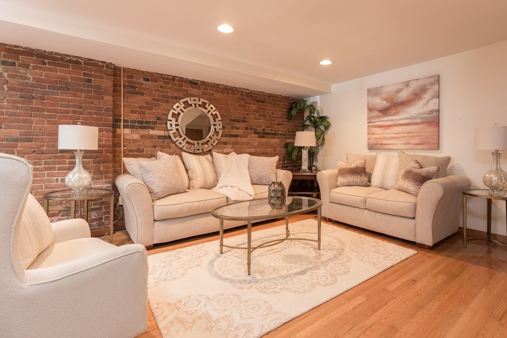 5 Durham Street, Unit 2 Boston, MA 02115 - Photo 7 of 22 a living room with furniture and a wooden floor