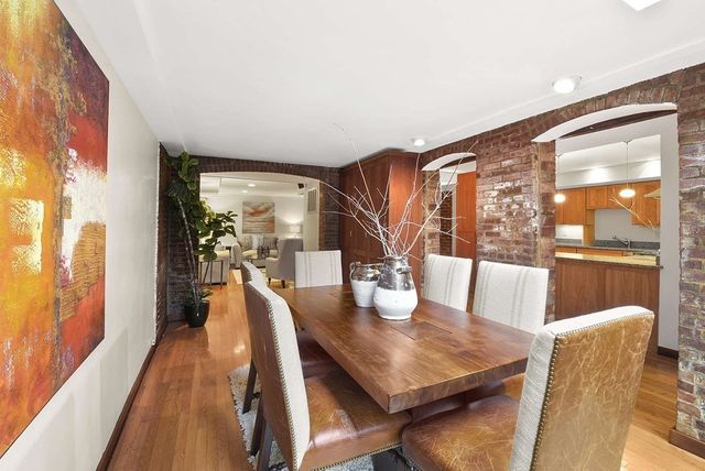 a dining room with furniture and wooden floor