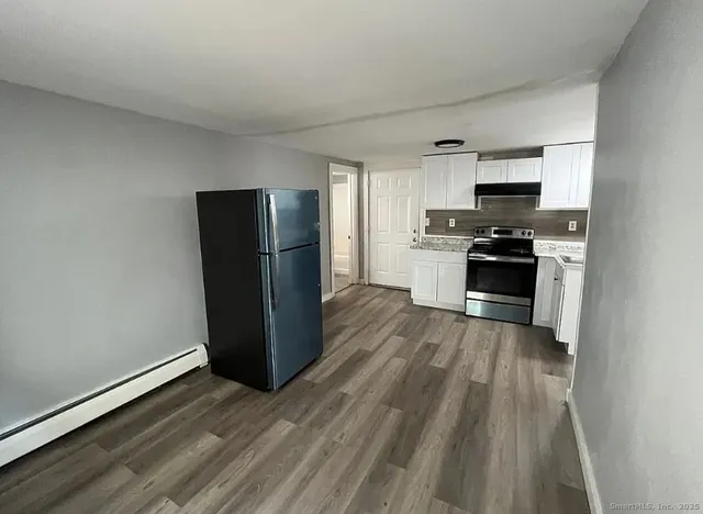 a kitchen with stainless steel appliances granite countertop a refrigerator stove and sink