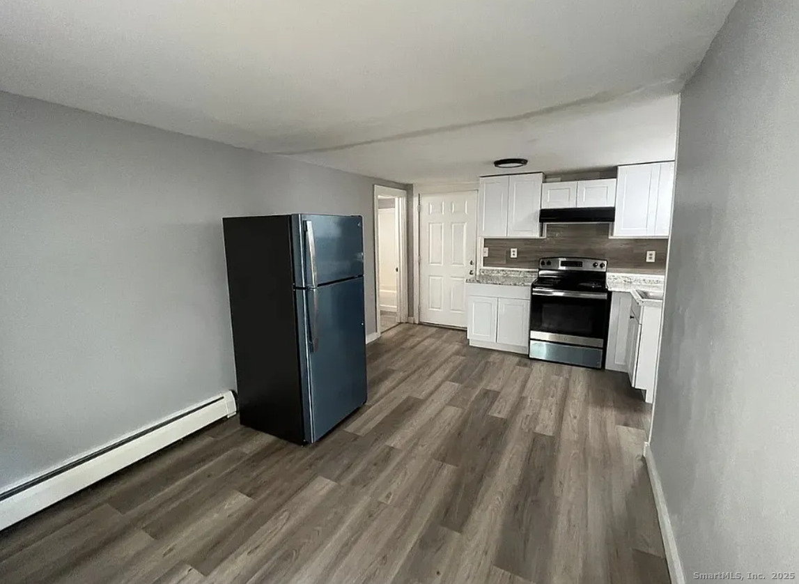 44 Green Street Middletown, CT 06457 - Photo 4 of 5 a kitchen with stainless steel appliances granite countertop a refrigerator stove and sink