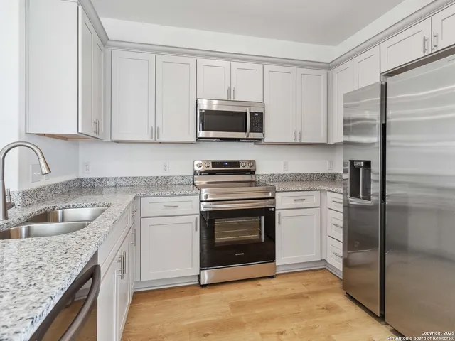 a kitchen with a sink stove and refrigerator
