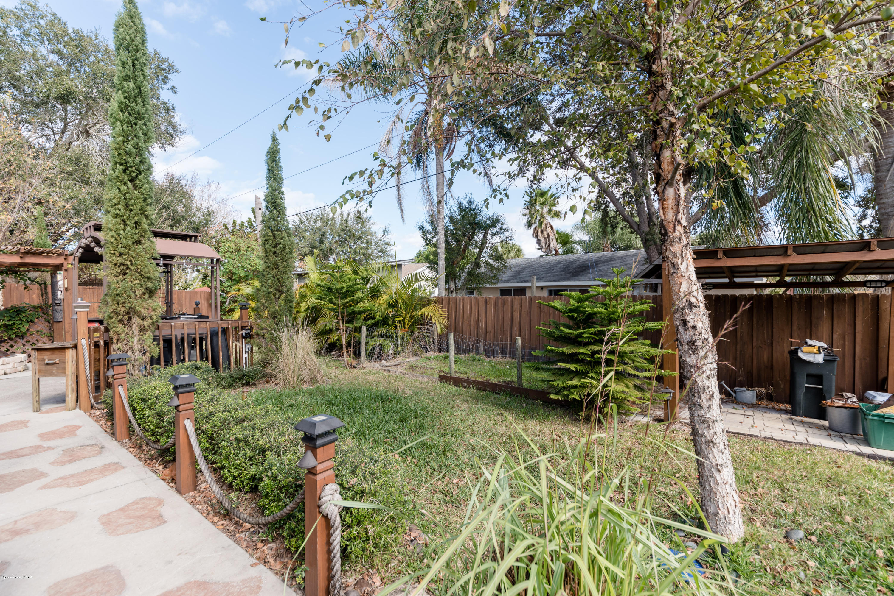 253 Chase Road Cocoa, FL 32927 - Photo 12 of 22 a view of a garden with sitting area