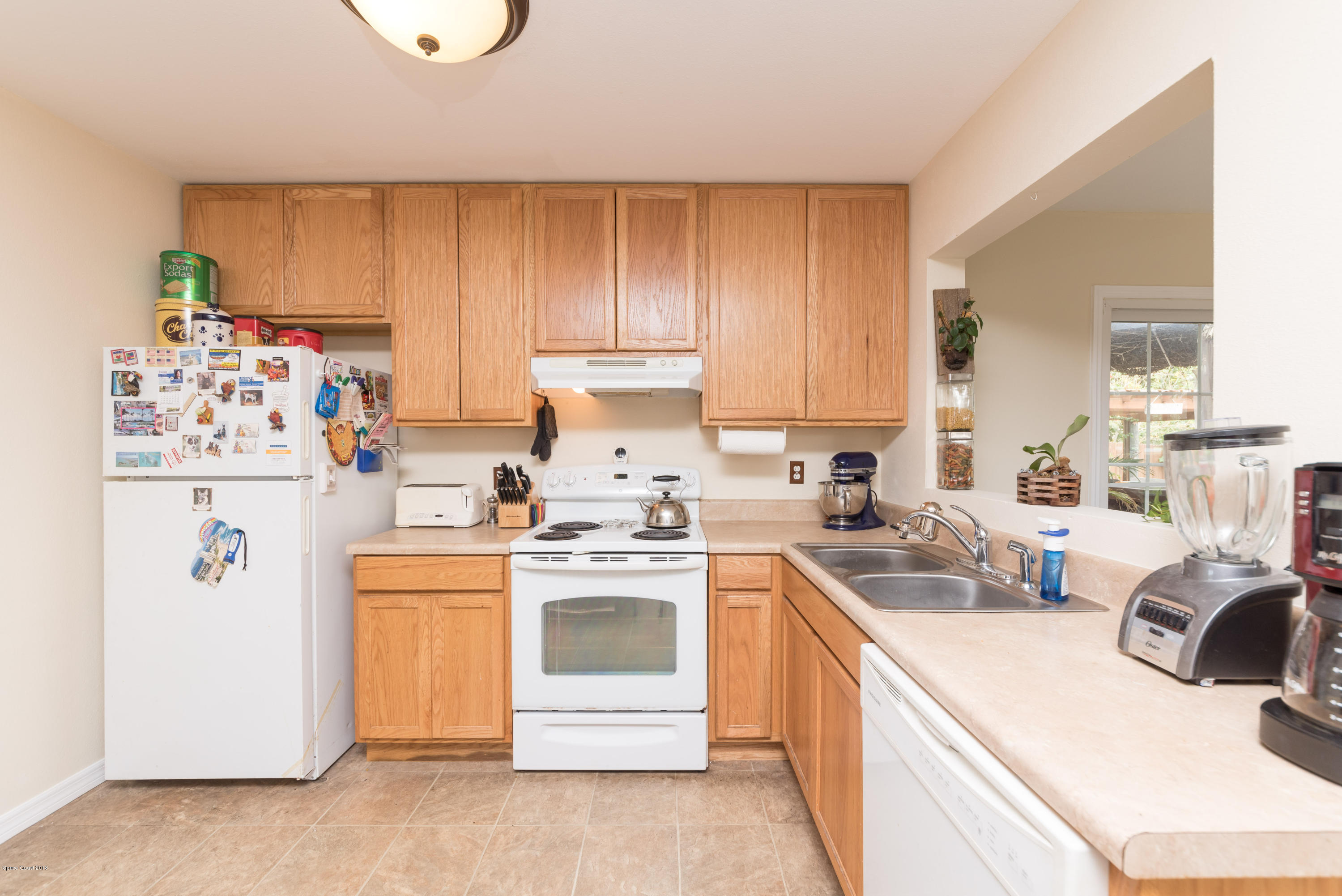 253 Chase Road Cocoa, FL 32927 - Photo 13 of 22 a kitchen with a white stove top oven sink and cabinets