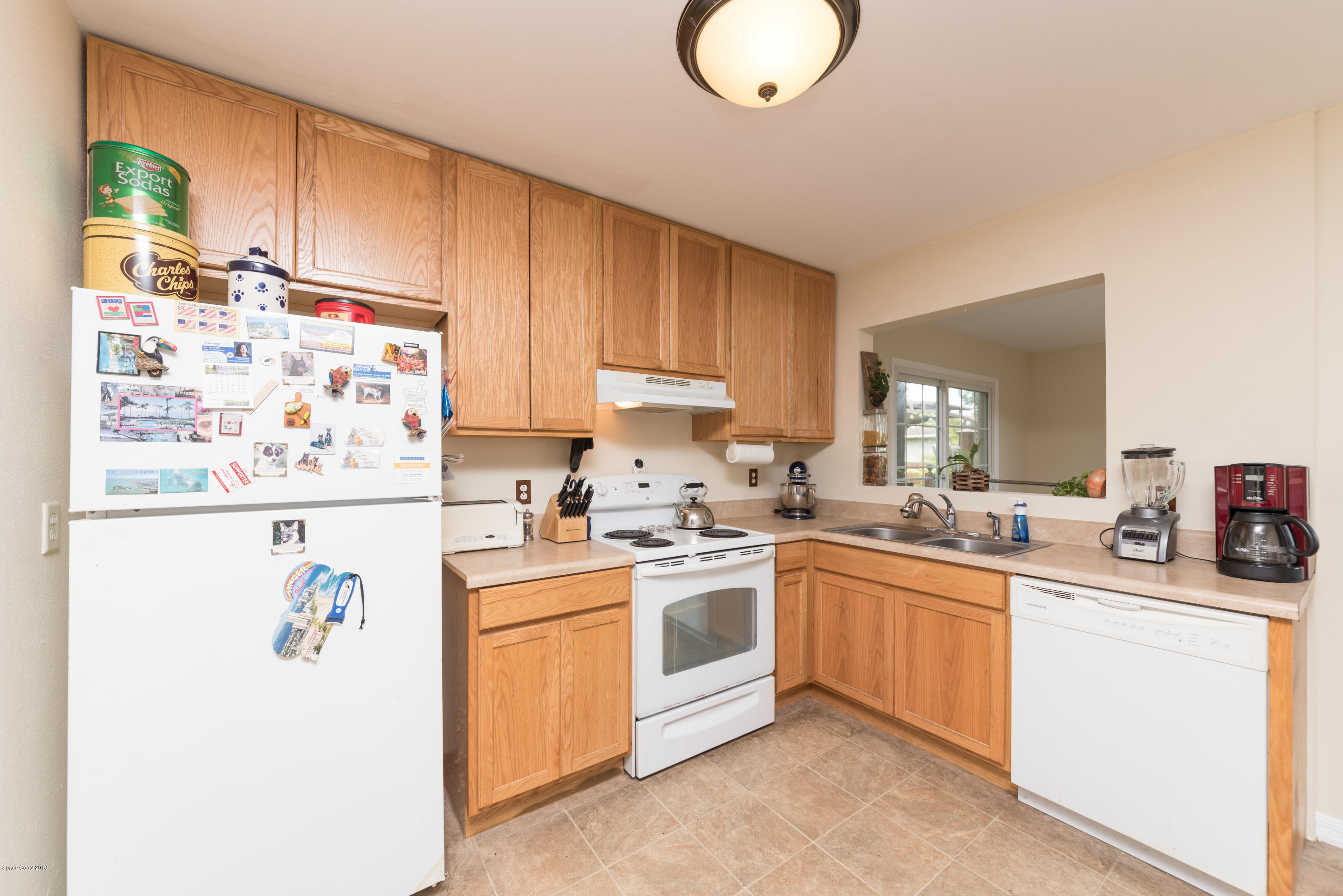 253 Chase Road Cocoa, FL 32927 - Photo 14 of 22 a kitchen with a sink a stove a refrigerator and cabinets