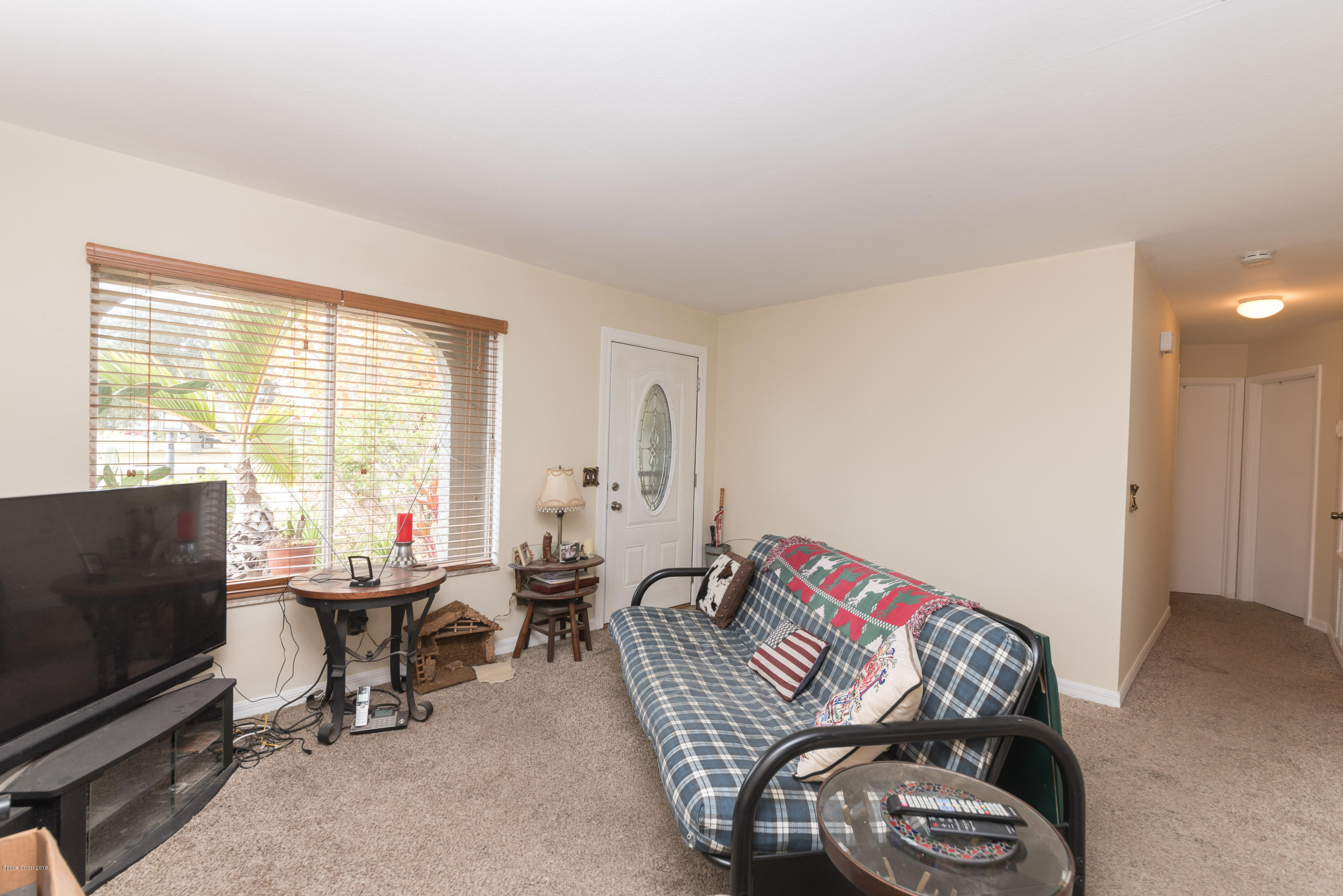 253 Chase Road Cocoa, FL 32927 - Photo 17 of 22 a living room with furniture a flat screen tv and a window