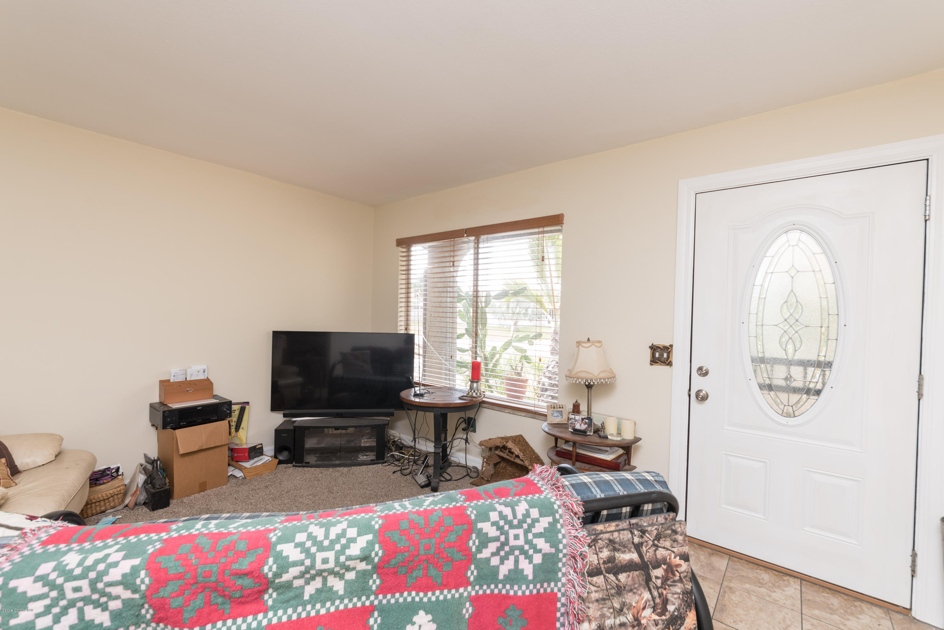 253 Chase Road Cocoa, FL 32927 - Photo 18 of 22 a living room with furniture and a flat screen tv
