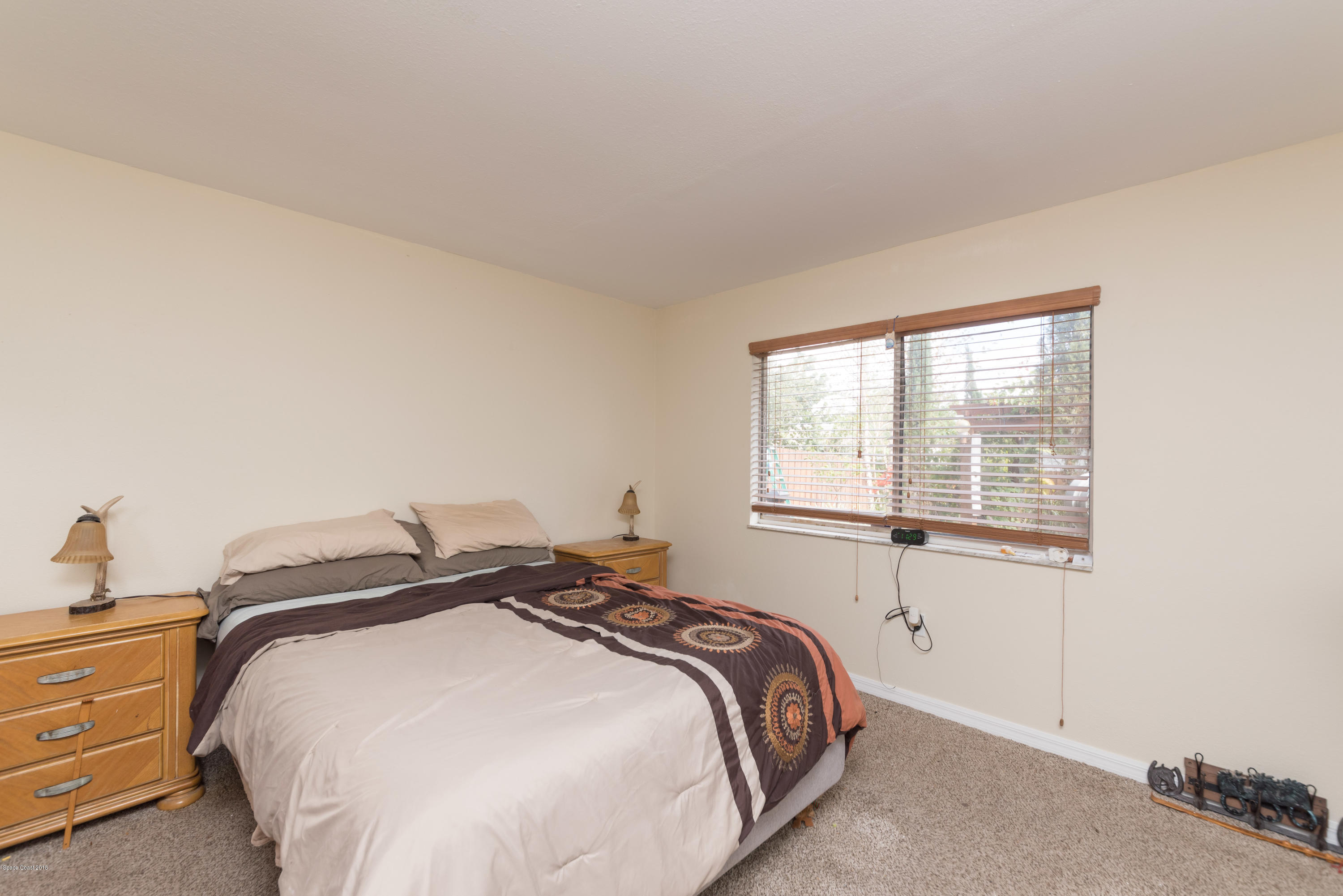253 Chase Road Cocoa, FL 32927 - Photo 20 of 22 a bedroom with a bed and a window