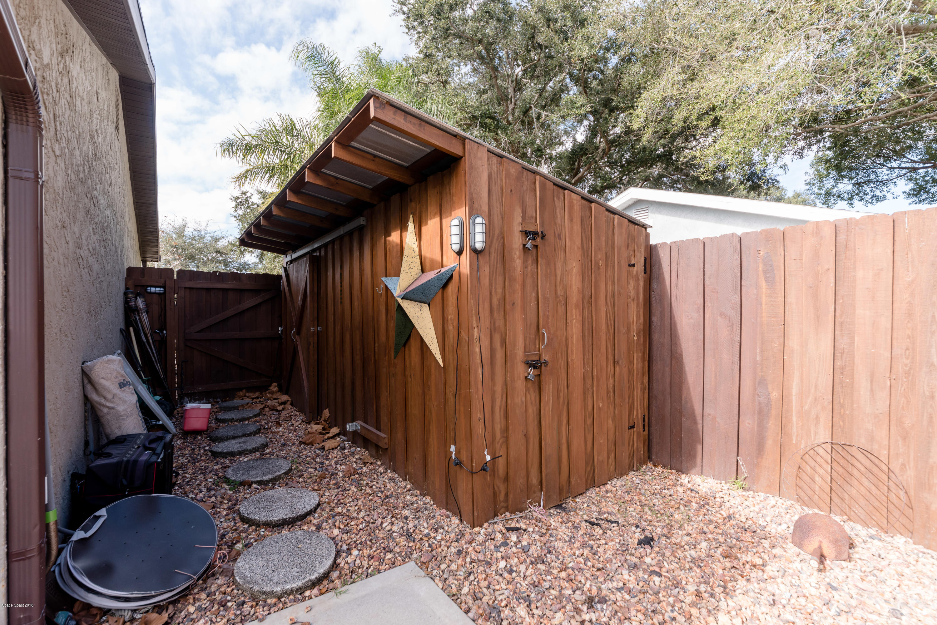 253 Chase Road Cocoa, FL 32927 - Photo 4 of 22 a backyard of a house with barbeque oven table and chairs