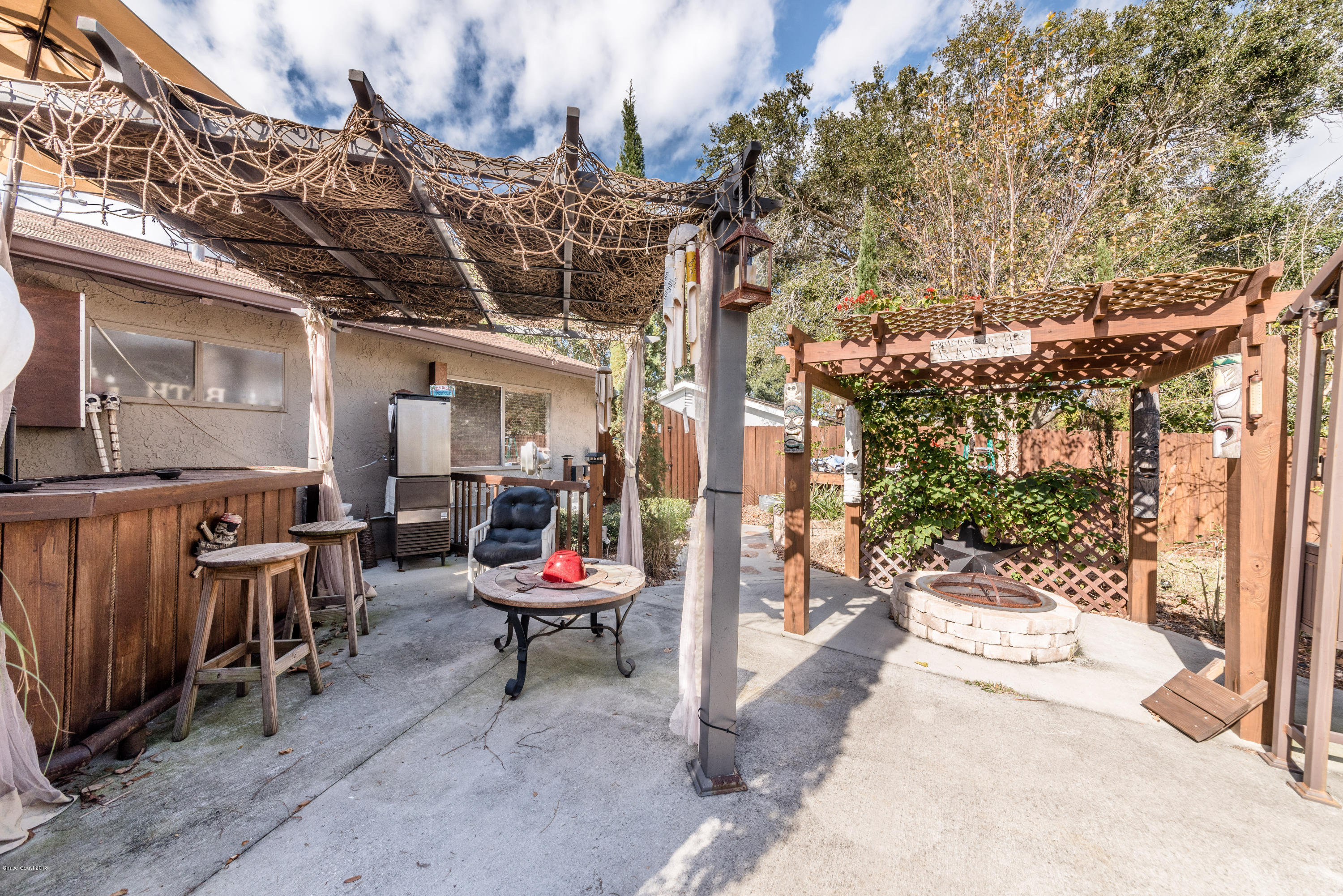 253 Chase Road Cocoa, FL 32927 - Photo 5 of 22 a view of a patio with table and chairs and potted plants
