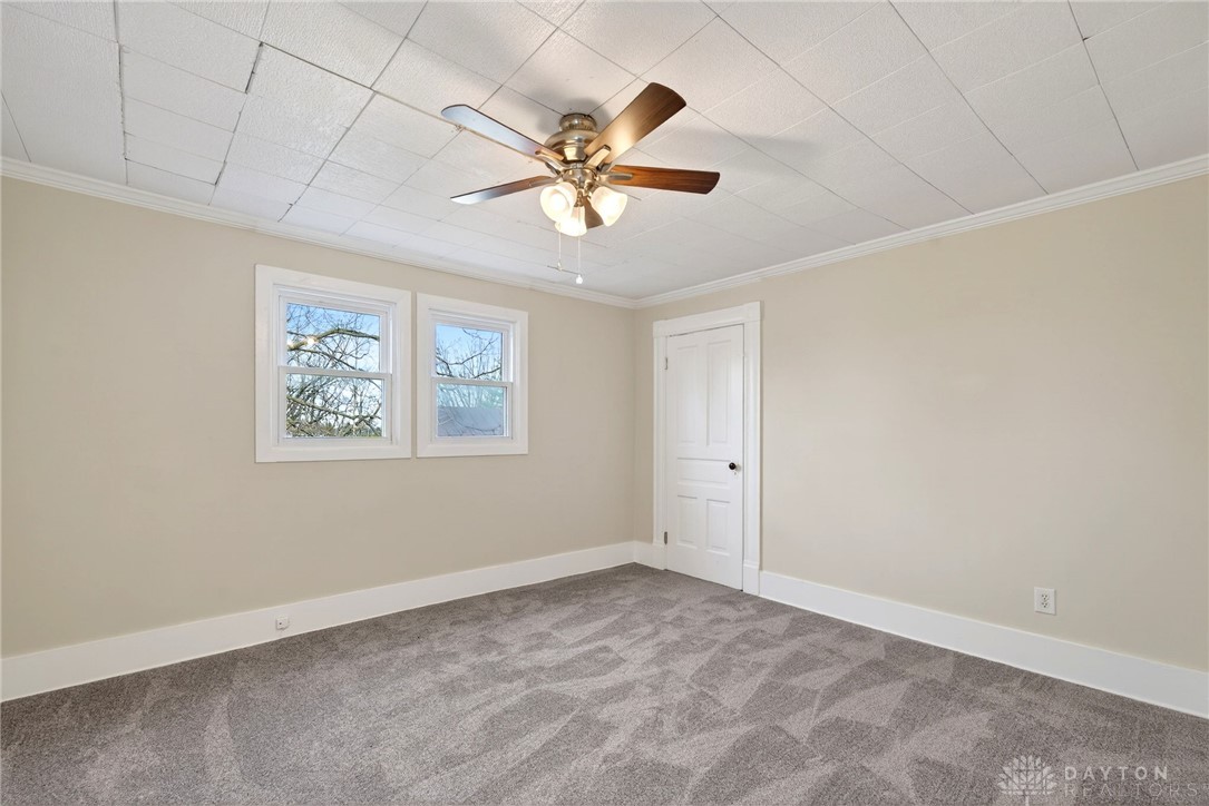 585 North Spring Street Wilmington, OH 45177 - Photo 18 of 21 This spacious bedroom offers ample natural light and a comfortable atmosphere for relaxation.