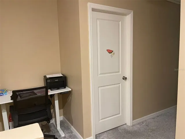 a bedroom with a bed and a night stand