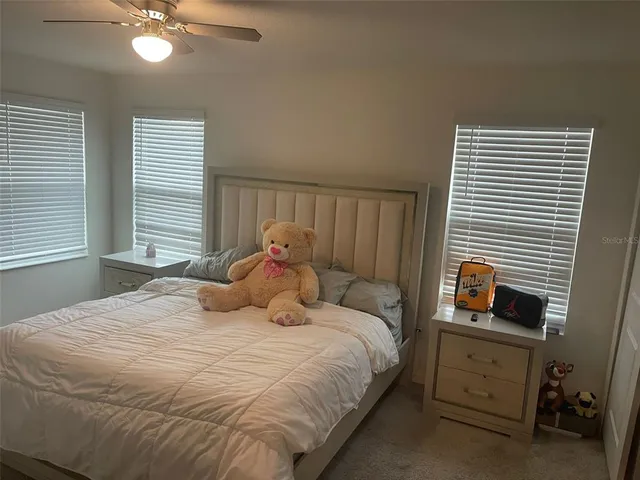 a bedroom with a bed and a television