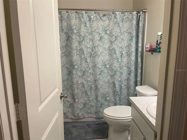a bathroom with a toilet and shower