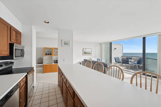 a living room with furniture a flat screen tv and a table