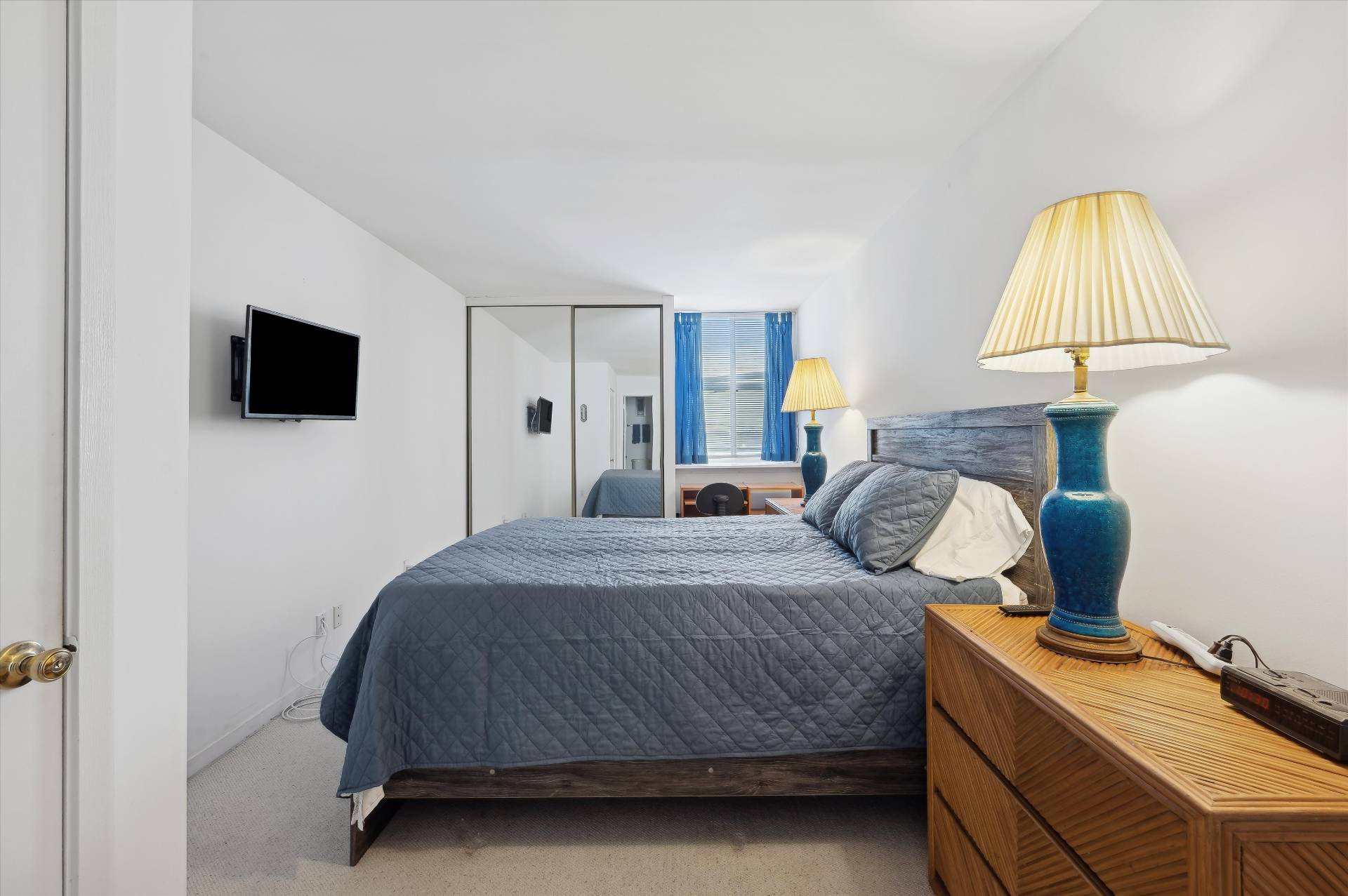 259 Dune Road, Unit 137 Westhampton Beach, NY 11978 - Photo 12 of 16 a bedroom with a bed and a flat screen tv