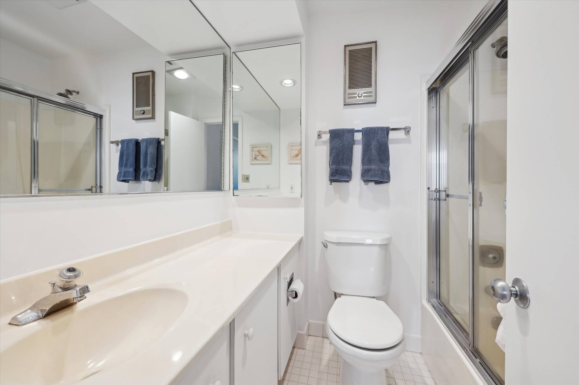 259 Dune Road, Unit 137 Westhampton Beach, NY 11978 - Photo 13 of 16 a bathroom with a toilet sink and mirror