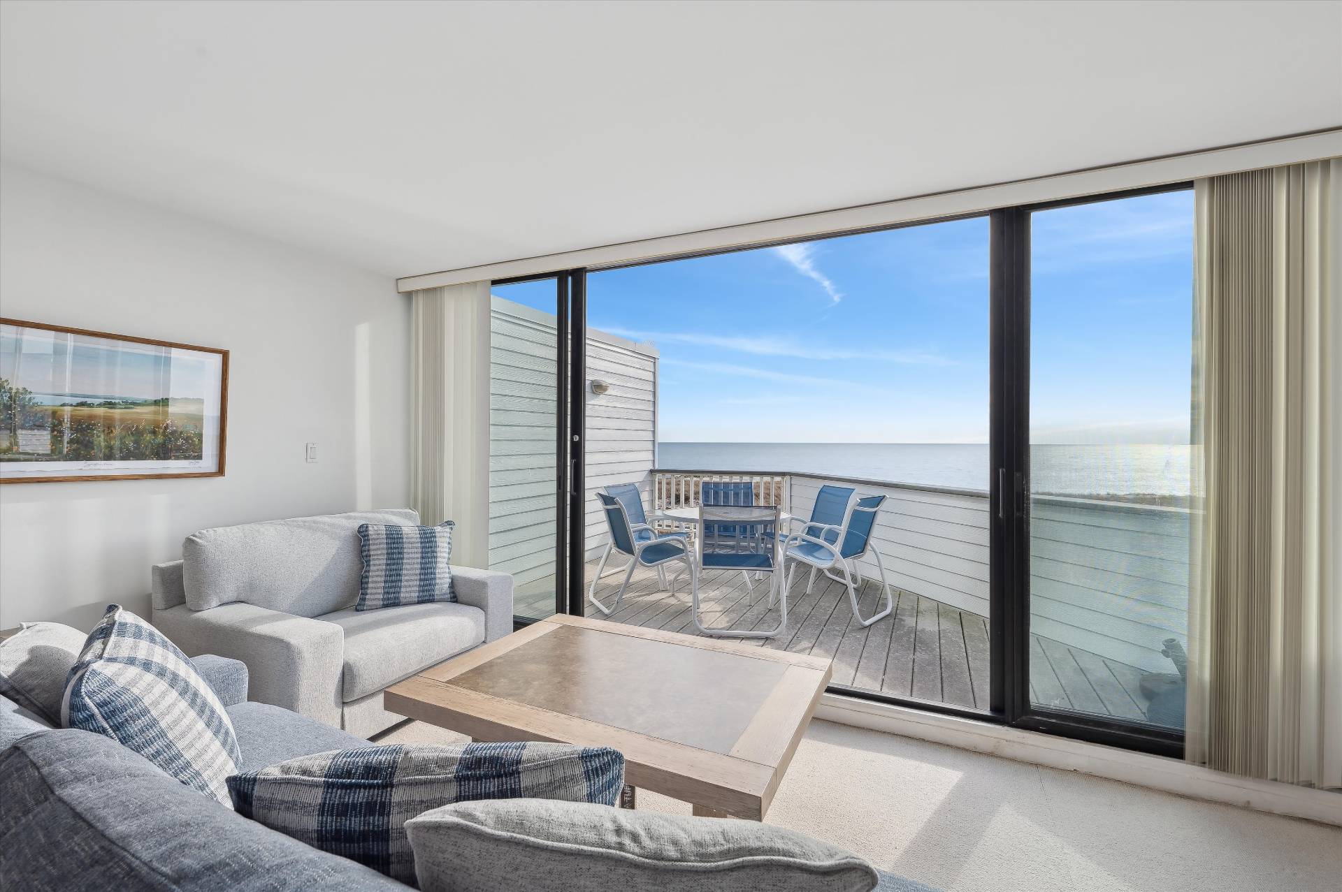 259 Dune Road, Unit 137 Westhampton Beach, NY 11978 - Photo 3 of 16 a living room with furniture and a large window