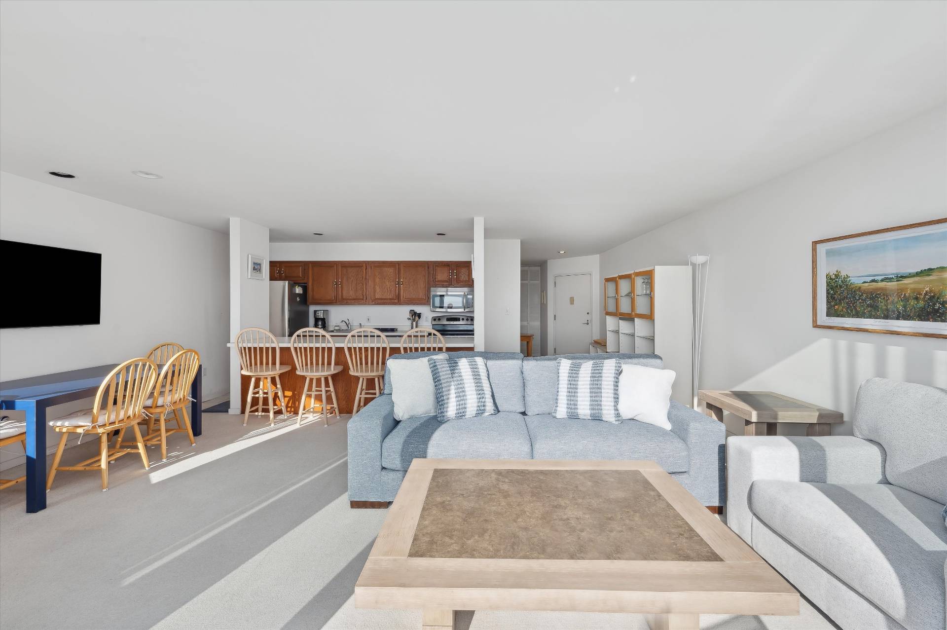 259 Dune Road, Unit 137 Westhampton Beach, NY 11978 - Photo 8 of 16 a living room with furniture and a flat screen tv