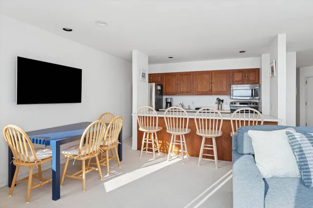 a view of a dining room with furniture and a flat screen tv