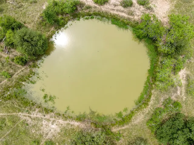 a view of a lake with a yard and mountain view