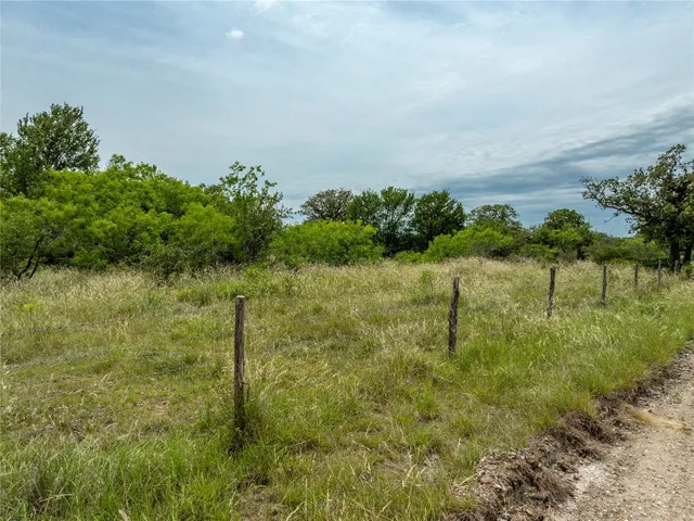 a view of a lake with a house in a yard