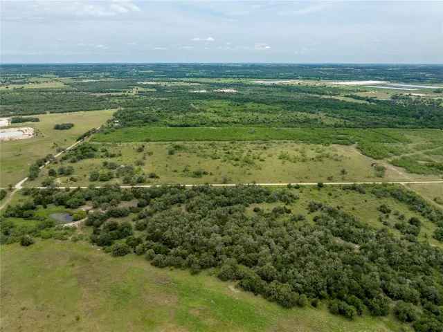 a view of a field with an ocean view