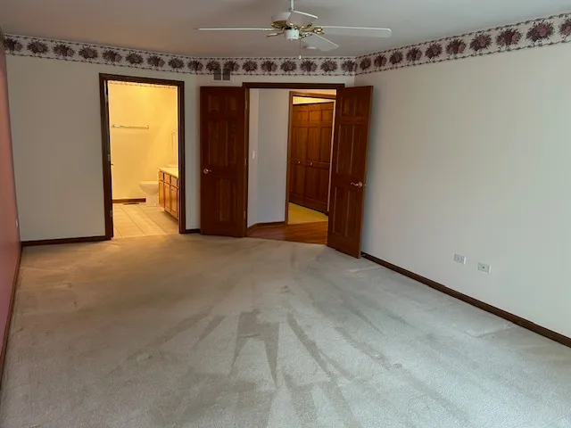 a kitchen with kitchen island granite countertop wooden floors and a view of living room