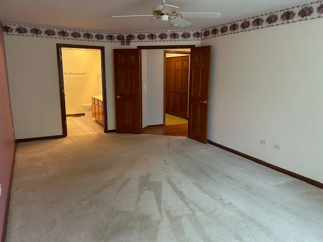 a kitchen with kitchen island granite countertop a sink a counter top space a stove and a refrigerator