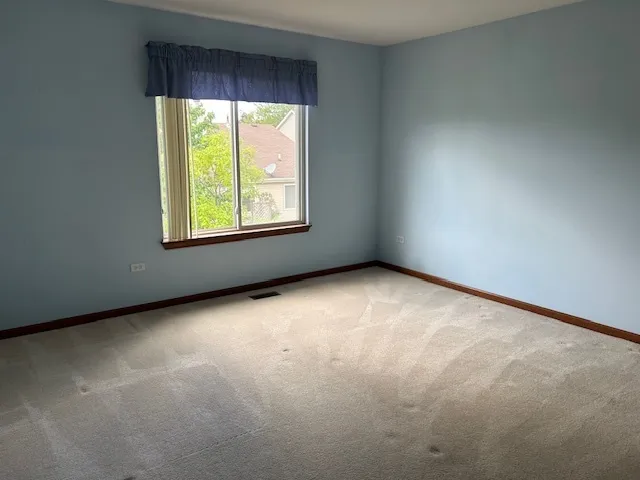 a bathroom with a granite countertop toilet and a sink