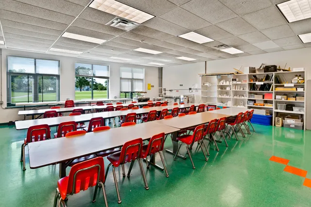 a living room with furniture and a book shelf