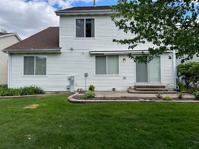 a front view of a house with a garden and yard