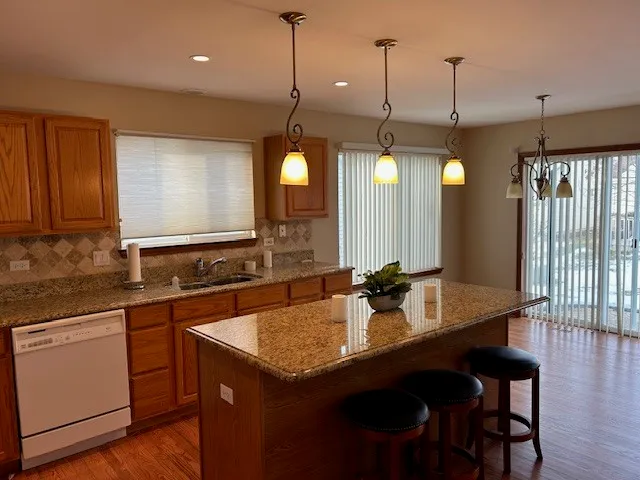 a kitchen with a sink a counter space appliances and cabinets