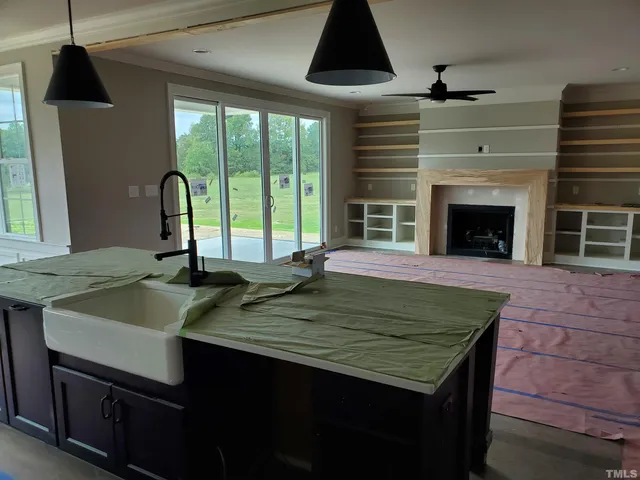 a kitchen with a sink a counter space and a fireplace