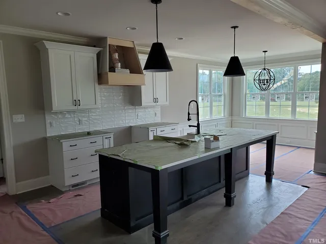 a kitchen with a sink cabinets and wooden floor