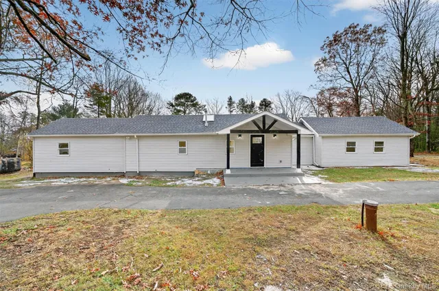 a view of a house with a snow on the road