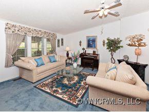 1197 Beaverdam Road Canton, NC 28716 - Photo 3 of 14 a living room with furniture and a chandelier