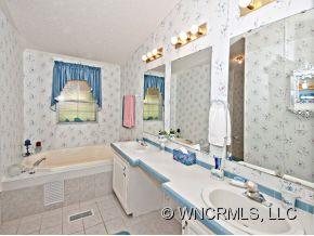 1197 Beaverdam Road Canton, NC 28716 - Photo 8 of 14 a bathroom with a tub sink and mirror