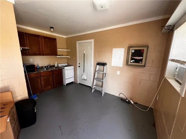 a kitchen with sink cabinets and wooden floor