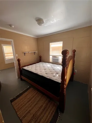 a bedroom with a bed a table and chair