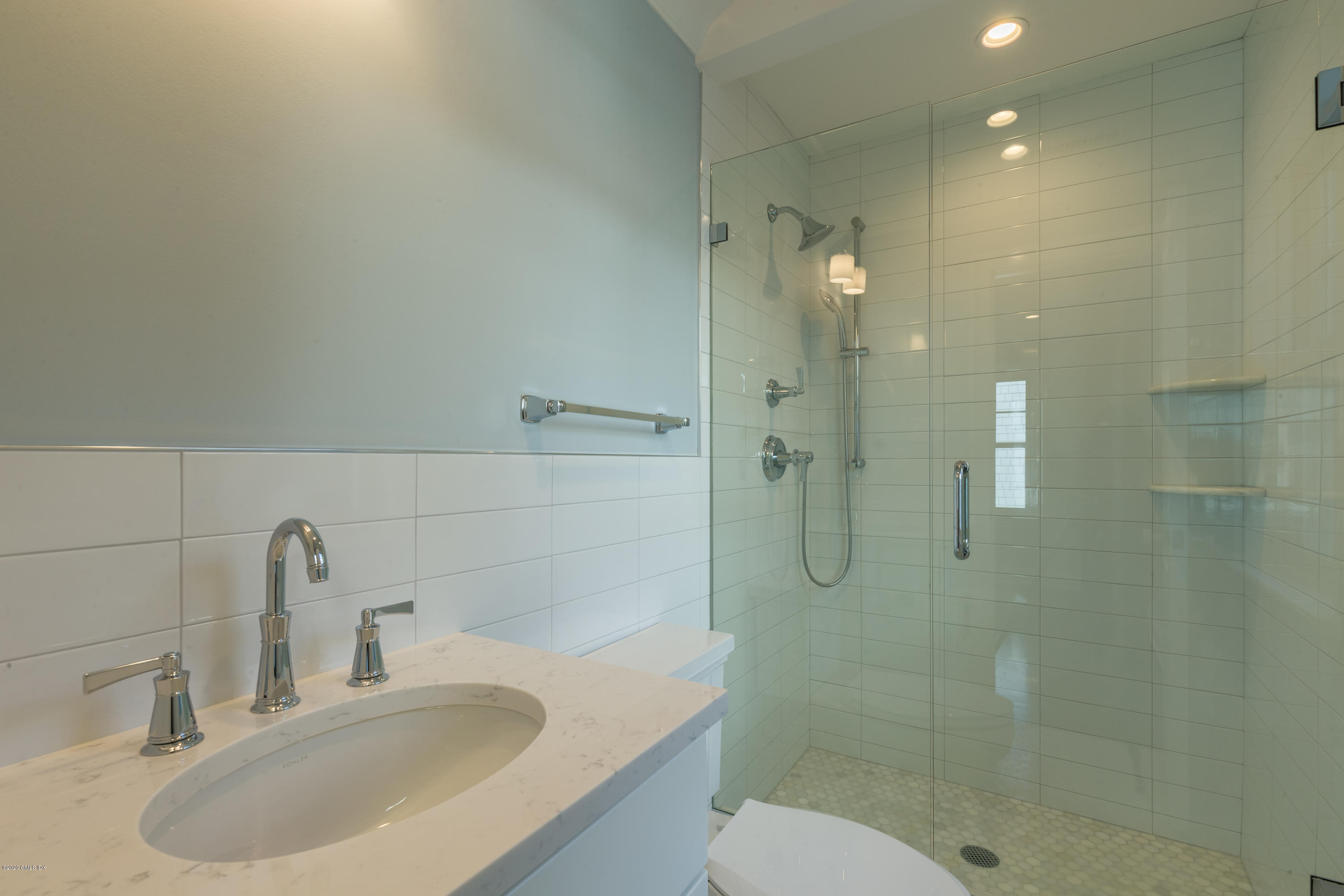 301 Davis Avenue, Unit B Greenwich, CT 06830 - Photo 12 of 16 a bathroom with a shower sink vanity and toilet