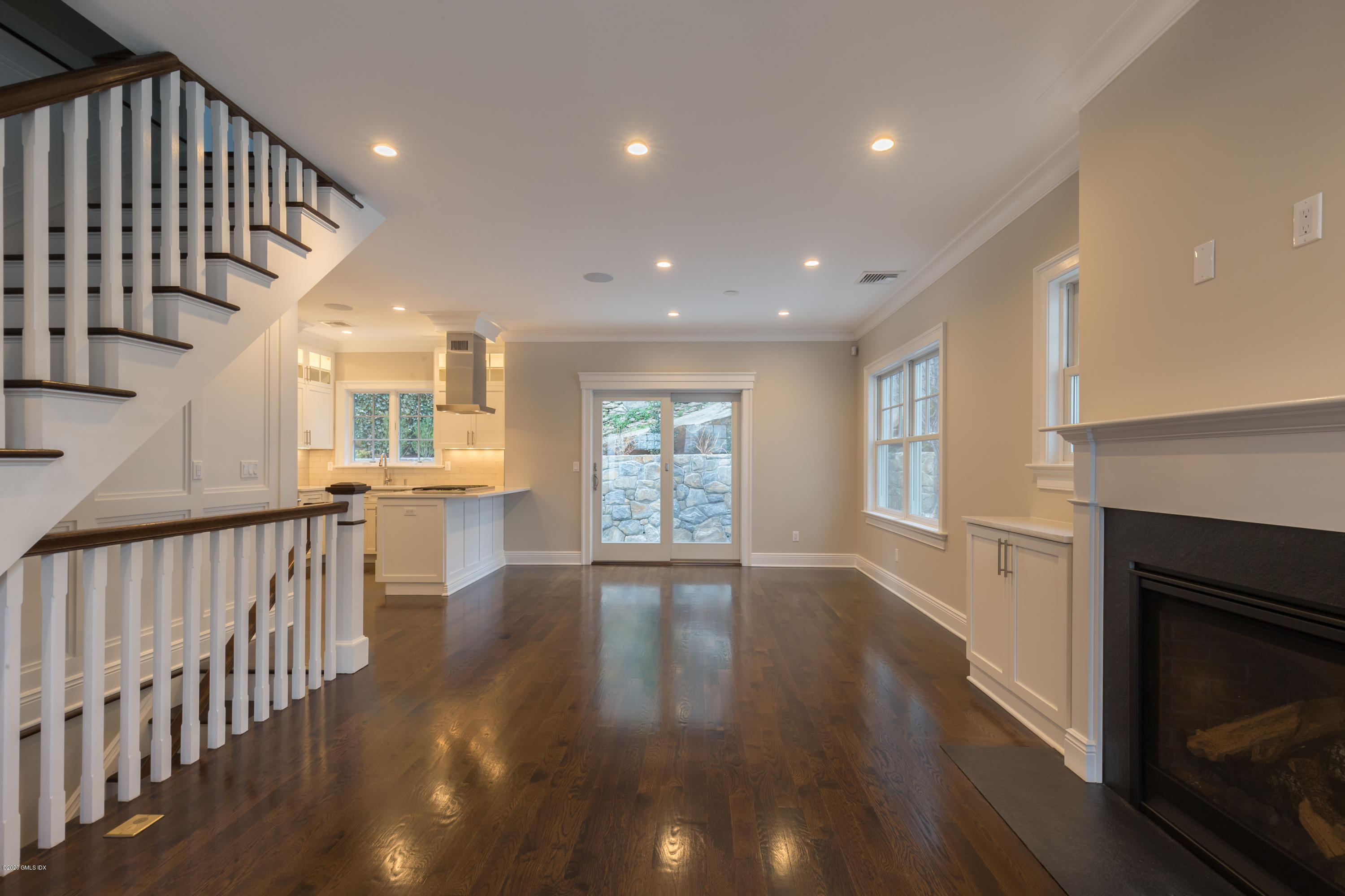 301 Davis Avenue, Unit B Greenwich, CT 06830 - Photo 4 of 16 a view of an empty room with wooden floor and a window