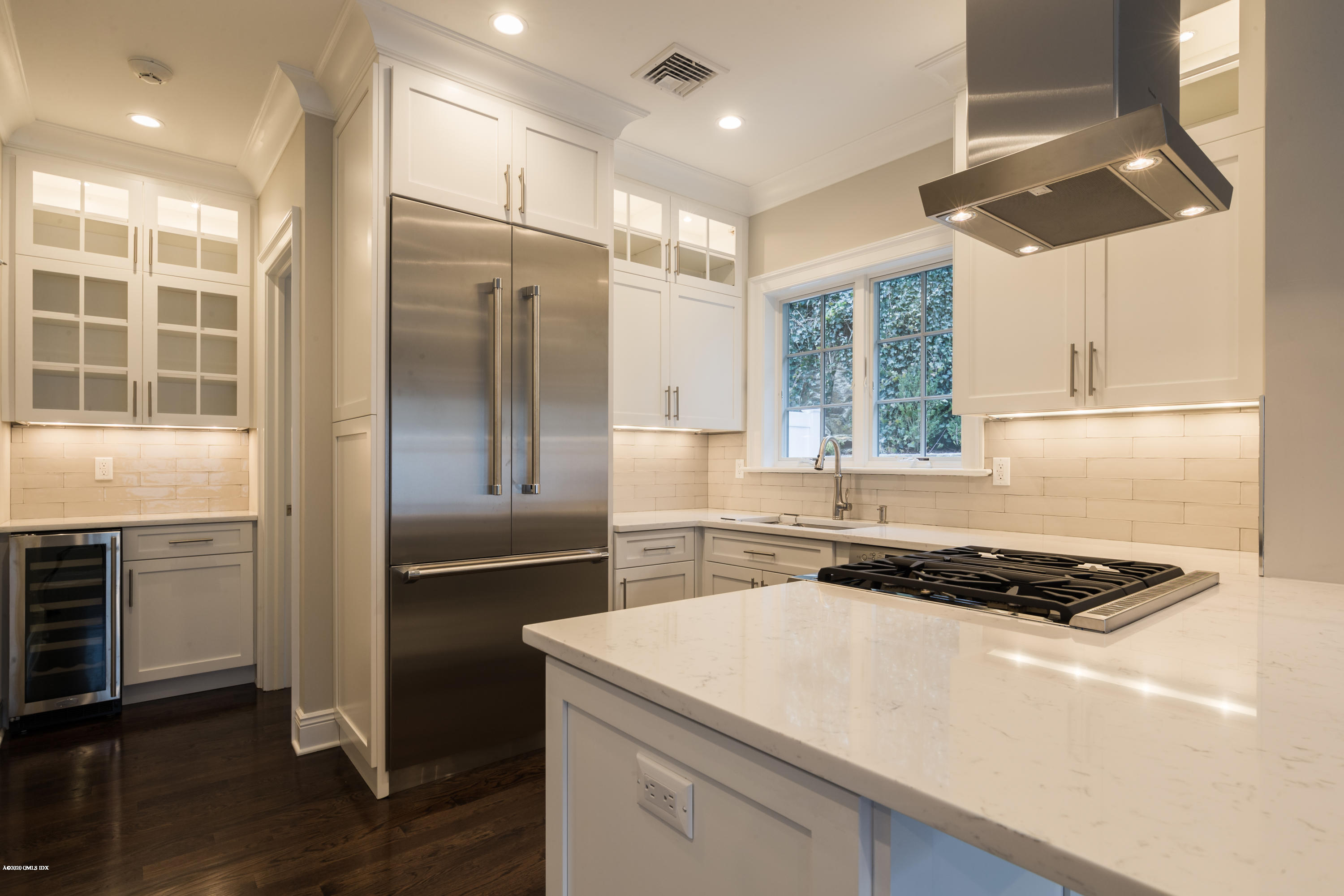 301 Davis Avenue, Unit B Greenwich, CT 06830 - Photo 5 of 16 a kitchen with a refrigerator and a stove top oven