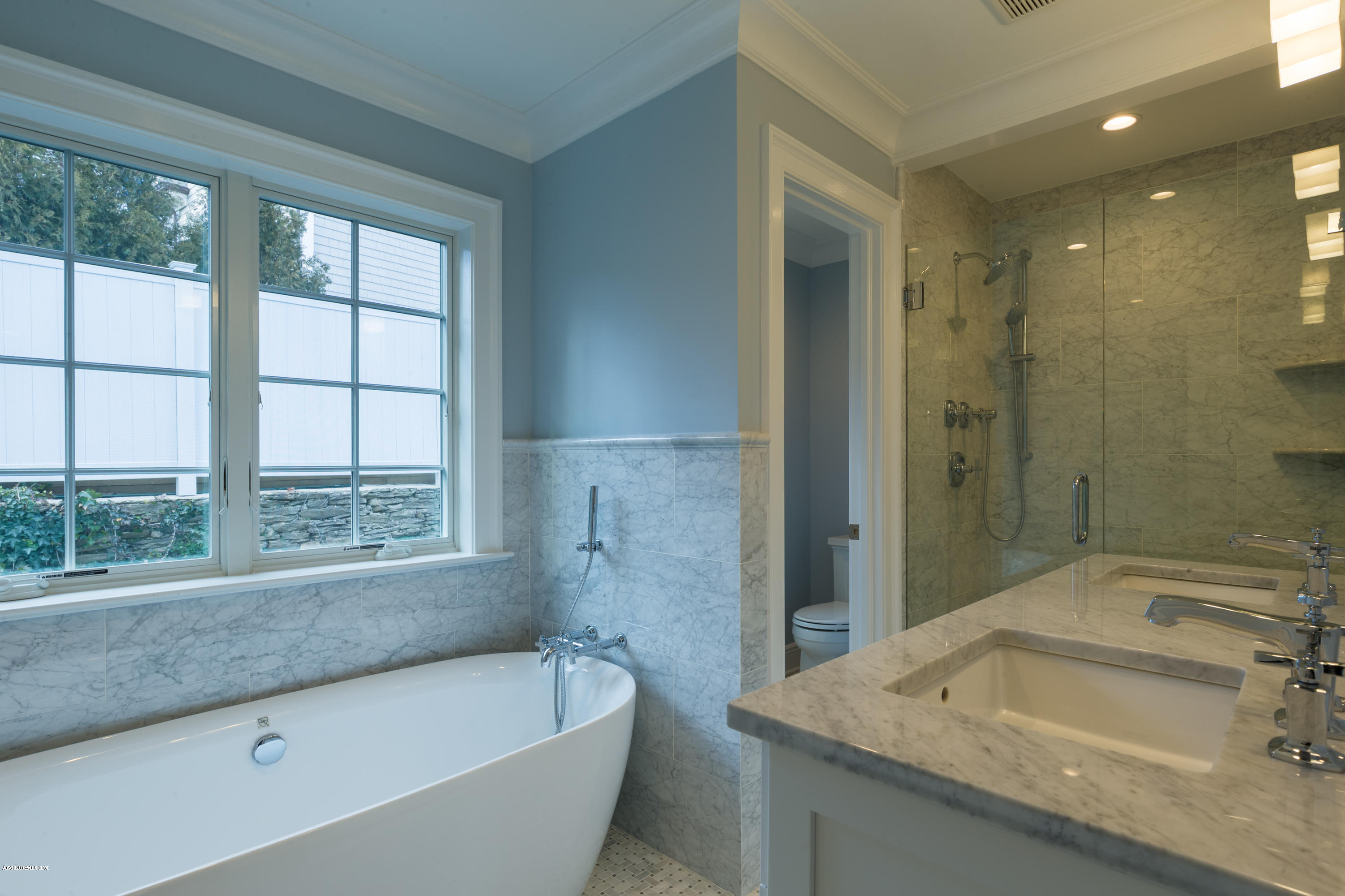 301 Davis Avenue, Unit B Greenwich, CT 06830 - Photo 7 of 16 a bathroom with a granite countertop tub sink and mirror