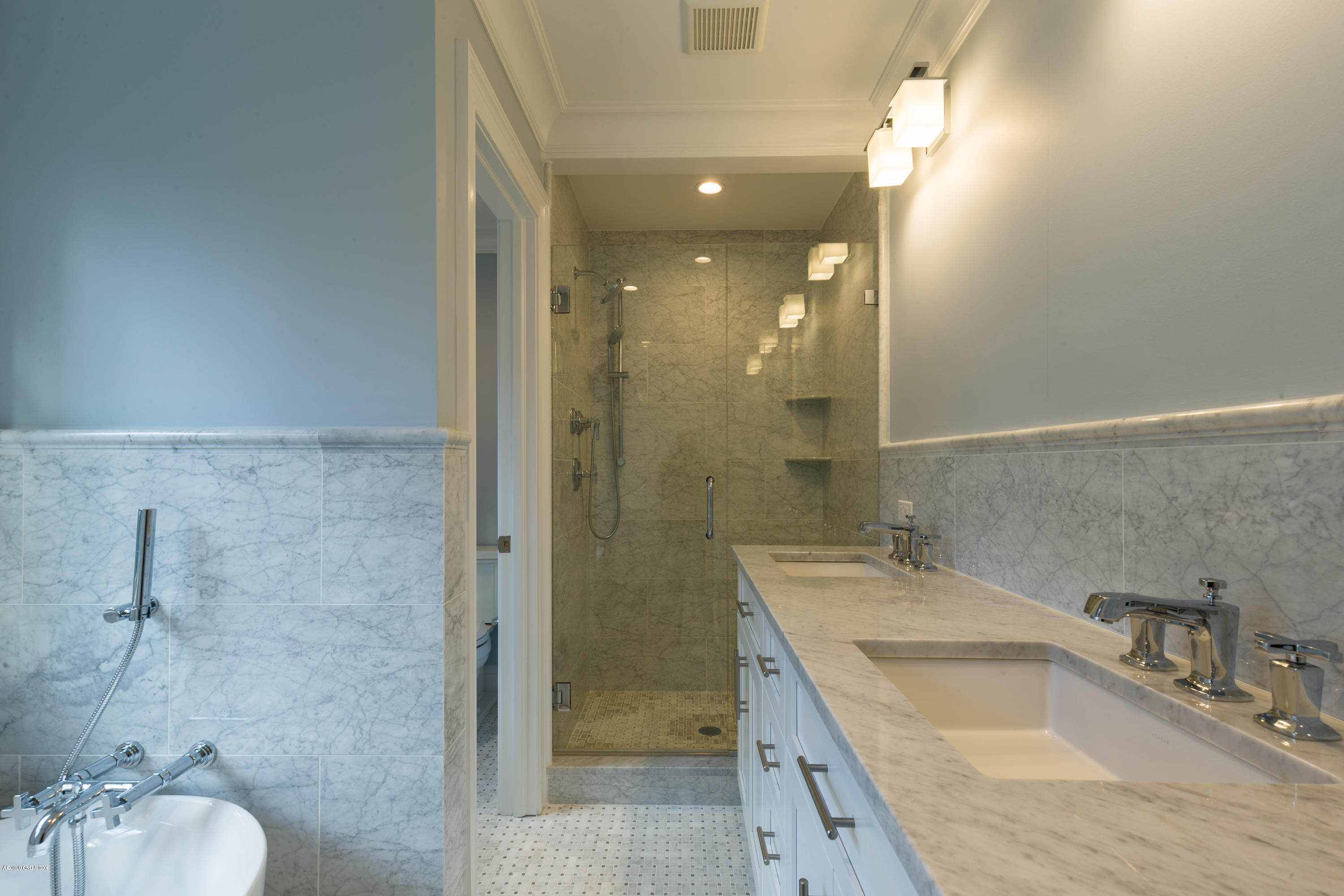 301 Davis Avenue, Unit B Greenwich, CT 06830 - Photo 10 of 16 a bathroom with a granite countertop sink a mirror and a shower