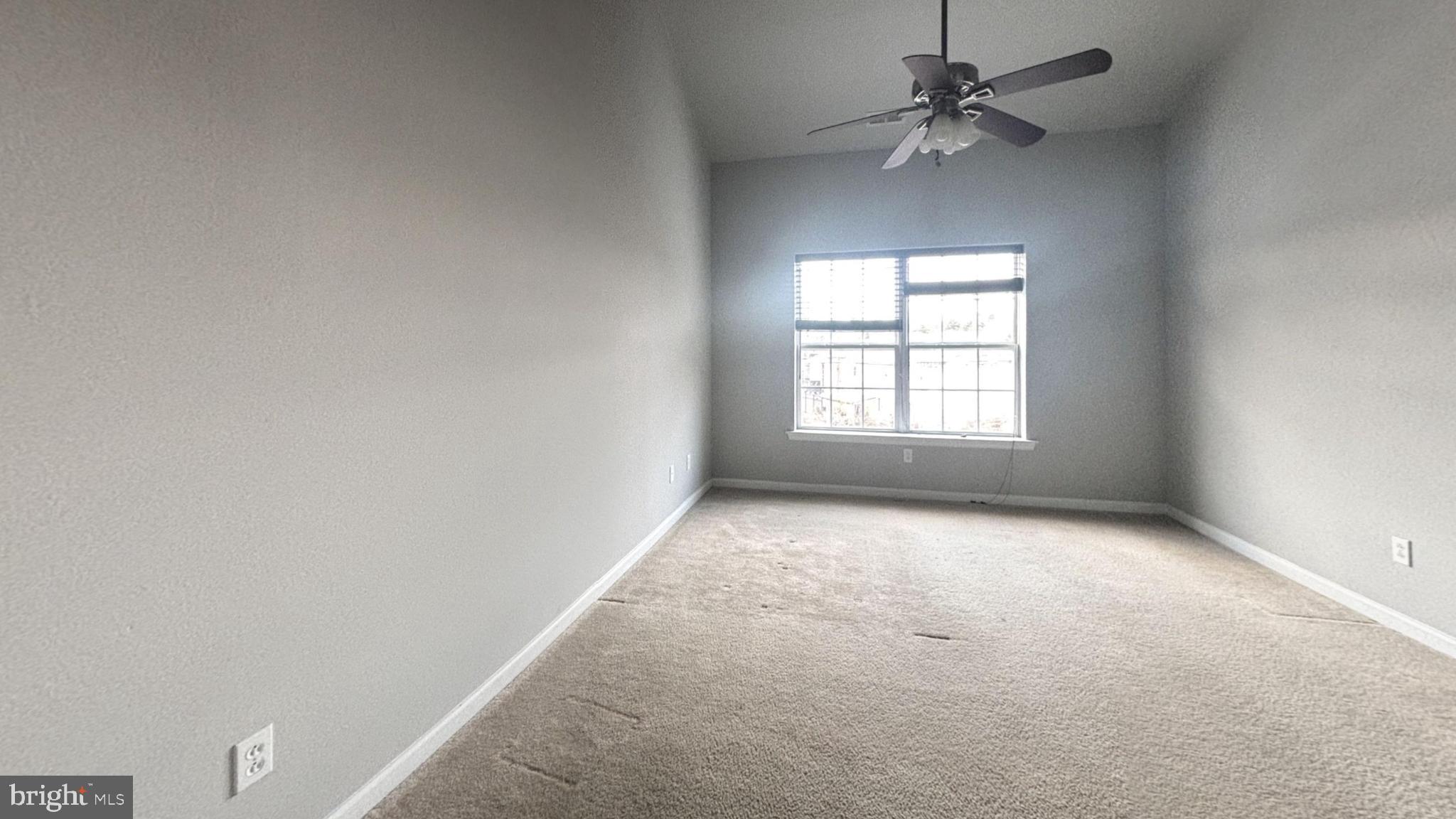 290 Byberry Road Philadelphia, PA 19116 - Photo 6 of 12 an empty room with a window and a fan