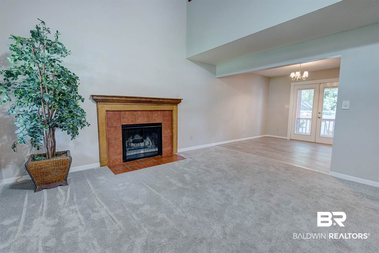 Features woodburning fireplace & cathedral ceiling