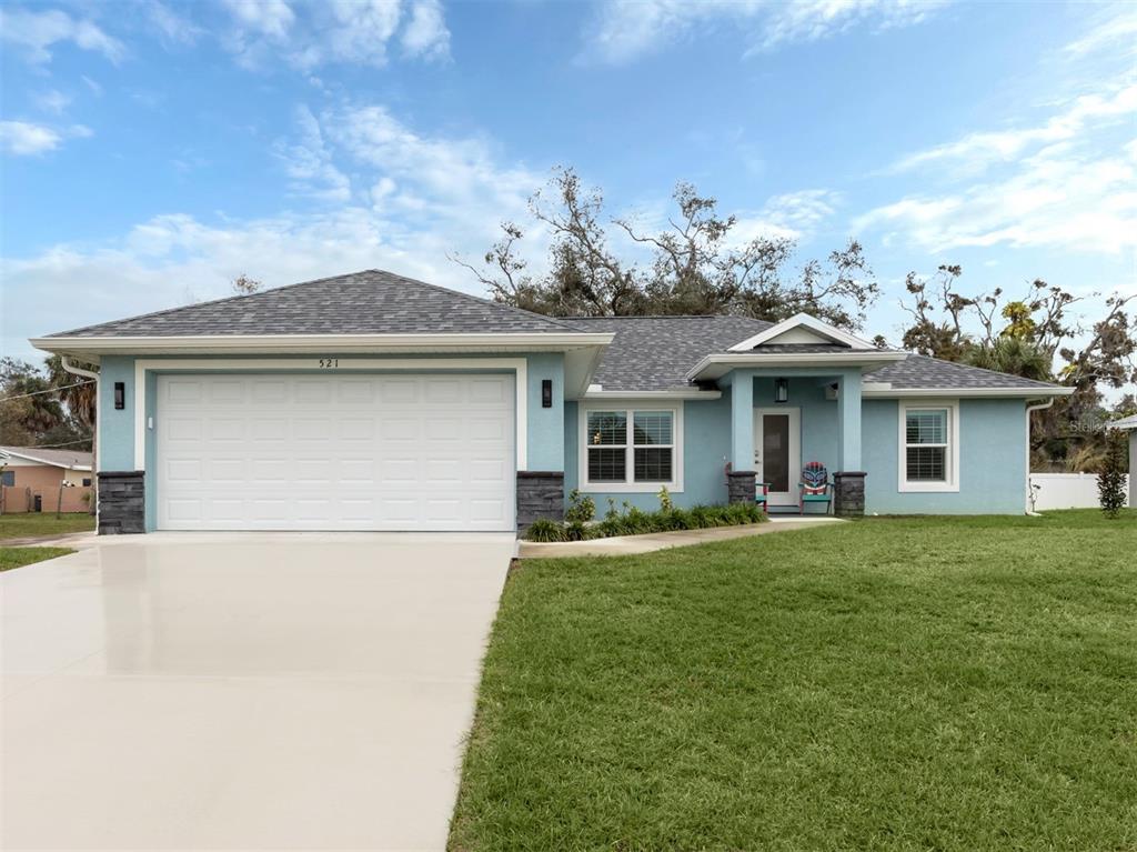521 Cabana Road Venice, FL 34293 - Photo 1 of 1 a front view of a house with a garden and plants